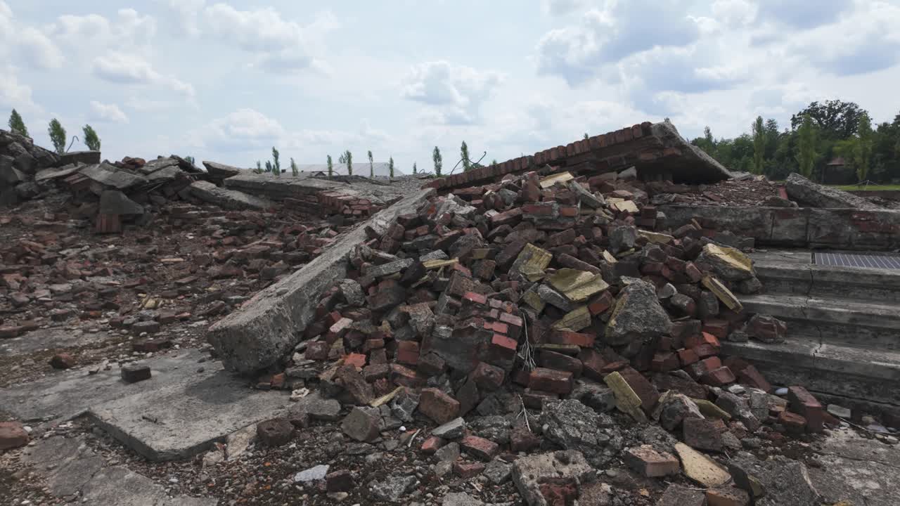 Ruins of Auschwitz-Birkenau concentration camp, featuring broken concrete and rubble. Poland