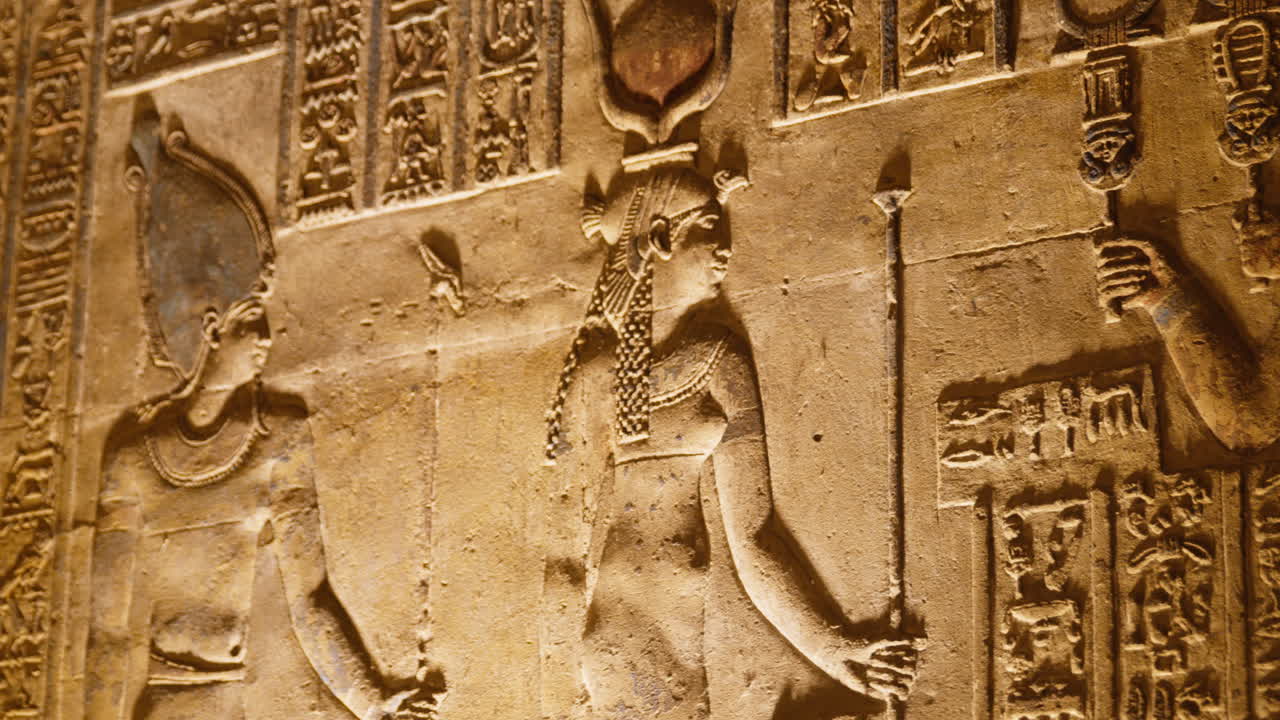 Ancient Egyptian wall carving with goddess and hieroglyphs, Dendera temple, Egypt