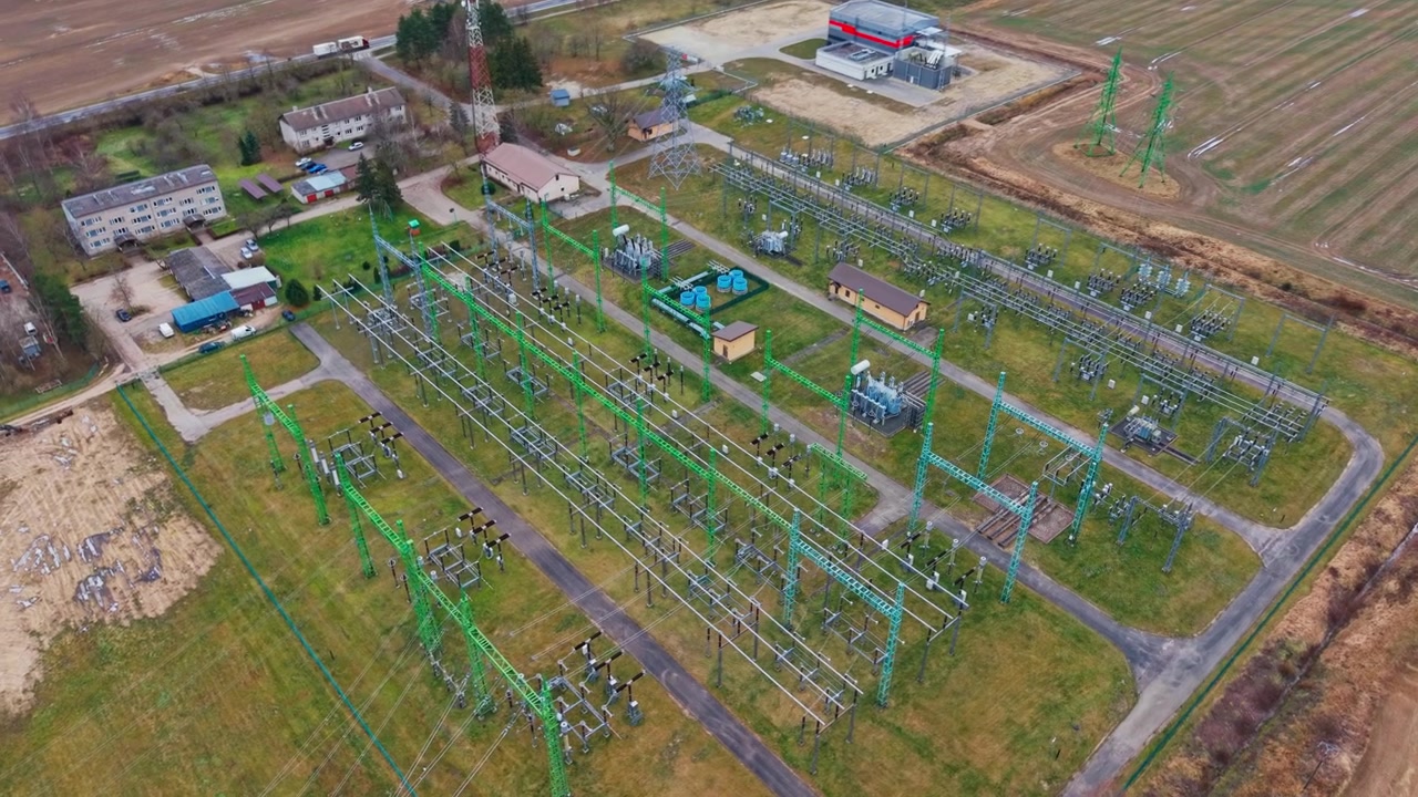 Critical energy infrastructure beside highway and homes, modern grid resilience