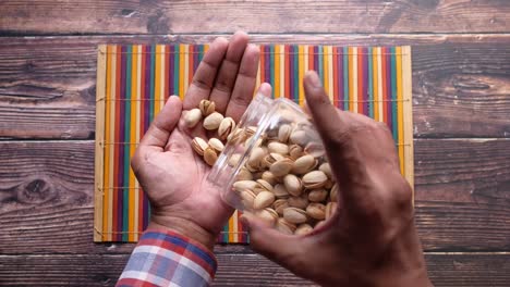 person holding a jar of pistachios