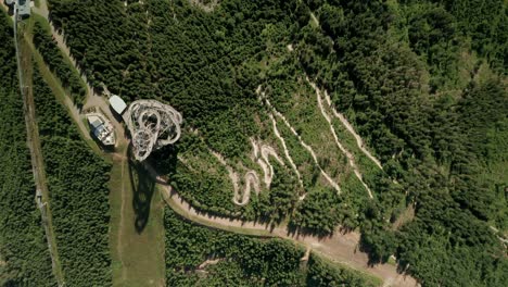 aerial birds-eye view of a sky walk tower attraction in dolni morava, czech republic and a nearby mtb bicycle trail