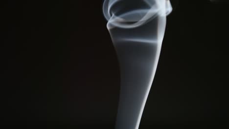slow motion: elegant line of smoke on a black background
