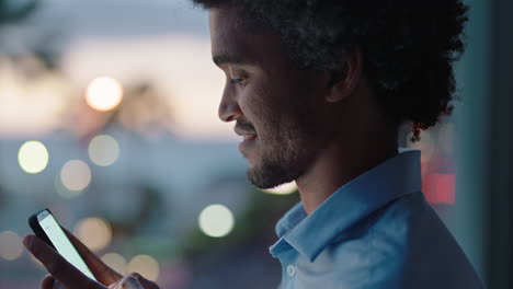 young-man-using-smartphone-in-hotel-room-texting-sharing-vacation-lifestyle-on-social-media-enjoying-view-of-ocean-at-sunset