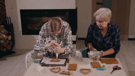 grandmother and granddaughter making gingerbread cookies