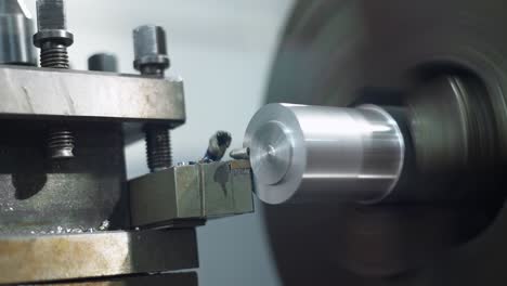 metal lathe machine while shaping and cutting a piece of metal