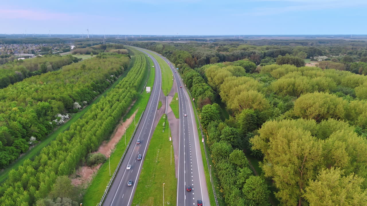 Road through green landscape. A scenic highway lined with greenery stretches through a vibrant landscape under a clear blue sky
