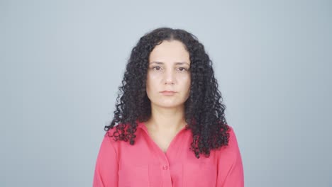 young woman looking at camera with dull expression.