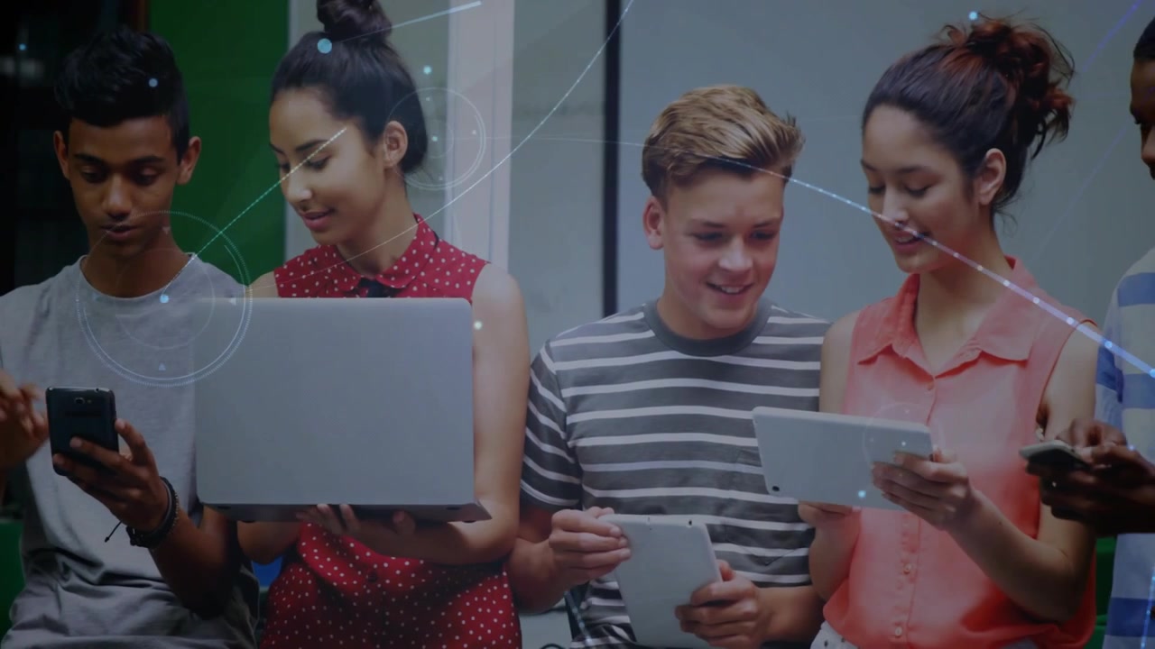 Rightmost lifting tablet starting classmates leaning in and sharing screens to compare content