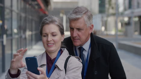 portrait happy senior caucasian couple using smartphone taking selfie photos posing enjoying making faces having fun together in city slow motion