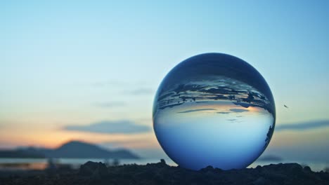 magic sunset view on the beach in a crystal ball.