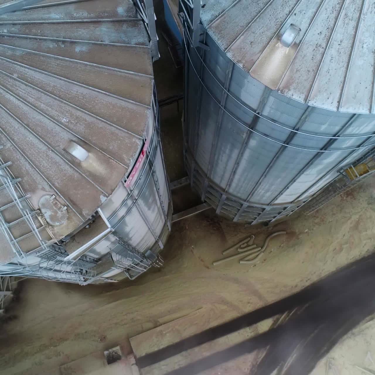 Big silo tanks with grain elevator. Huge elevator construction flight over