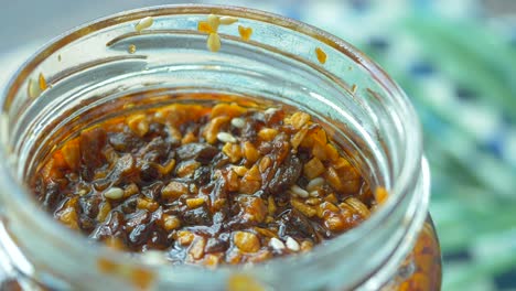 chili and garlic flakes in a container made with coconut oil