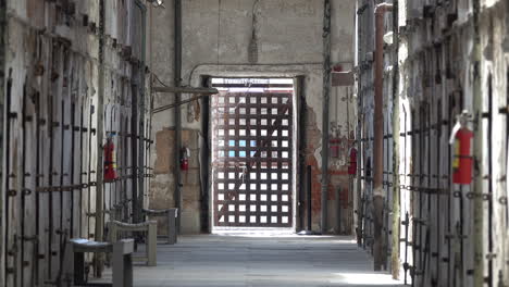 barred door and fire extinguishers in penitentiary cell block