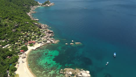 Cinematic-aerial-footage-of-a-sandy-beach-and-houses-in-tanote-bay-koh-tao,-Asia,-Thailand,-Drone