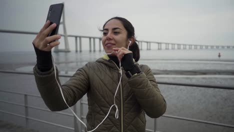 smiling hindu woman recording video for blog