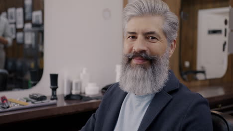 smiling senior man in barber shop