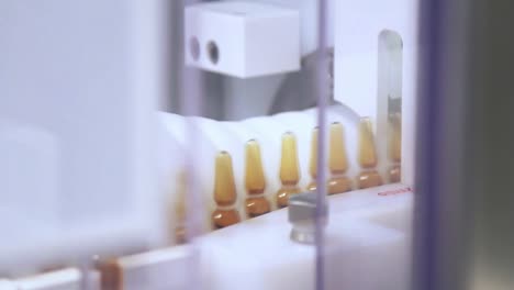 pharmaceutical manufacturing line at medical plant. ampoules on conveyor belt