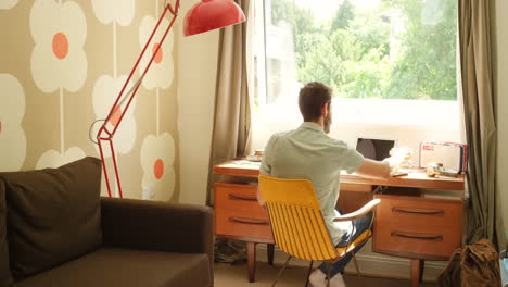 man working from home in a cozy retro-style living room