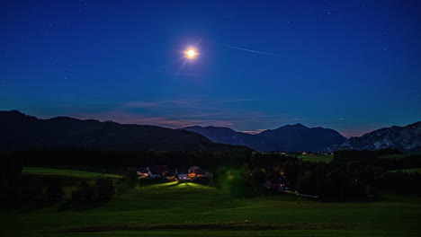 sunrise time lapse over austrian mountains with clear blue sky and moon