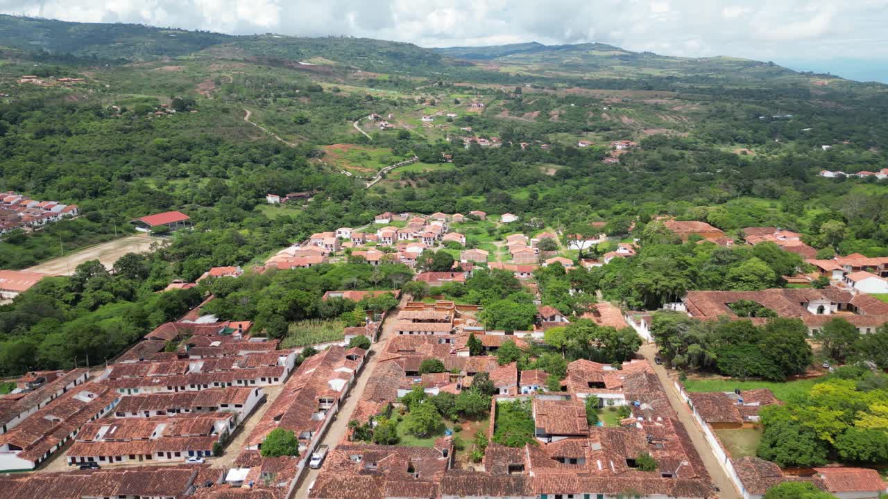 Scenic aerial views of the picturesque Andean village of Barichara in the Santander Department of Colombia, featuring colonial clay houses, red-tiled roofs, cobblestone streets and mountain scenery