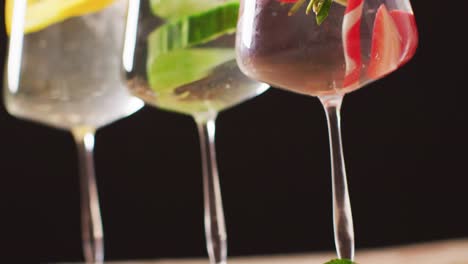 close up of drinks with fruit on wooden board