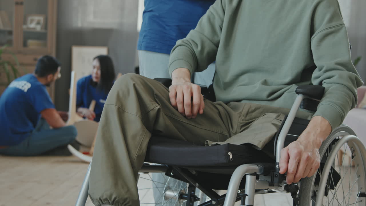 Portrait of Man in Wheelchair with African-American Female Volunteer