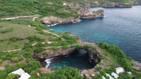 aerial view of broken beach with waves crashing into the cove