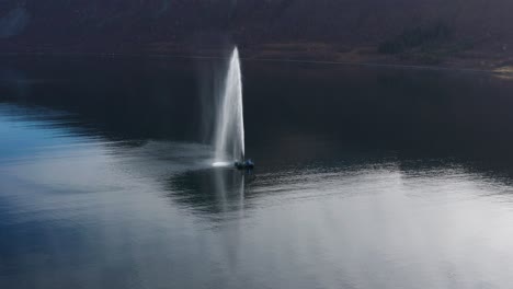 a fountain in the fjord near the small fishing village of torsken, norway