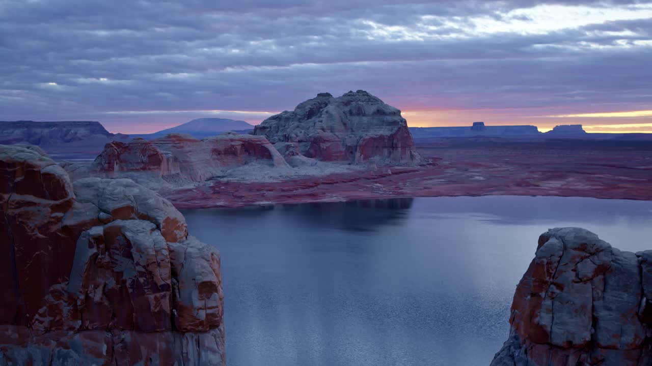 The drone hovers above Glen Canyon, providing a stunning view of its layered rock formations carved by wind and water.