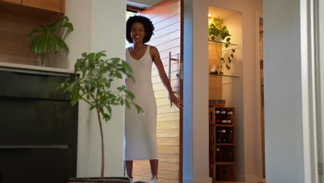 family returning home opening front door and children running in