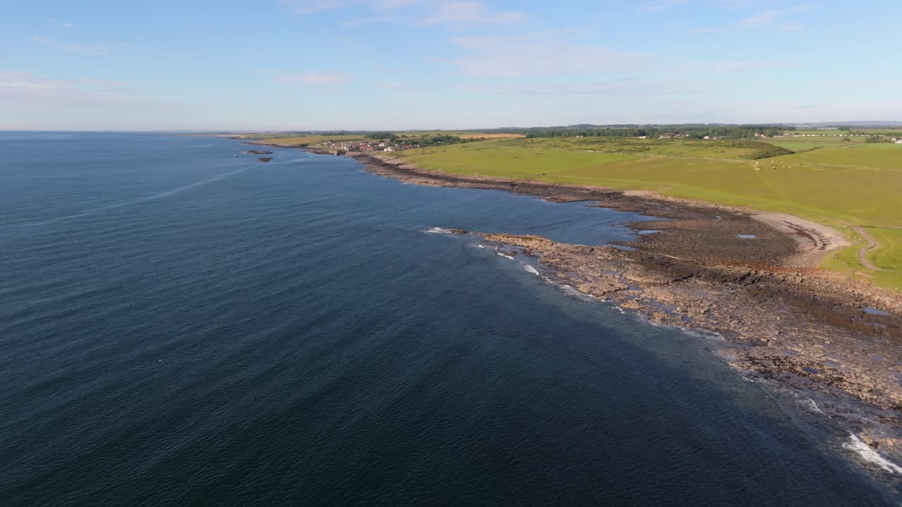 drone footage of Craster harbor village in Northumberland on a summers day morning