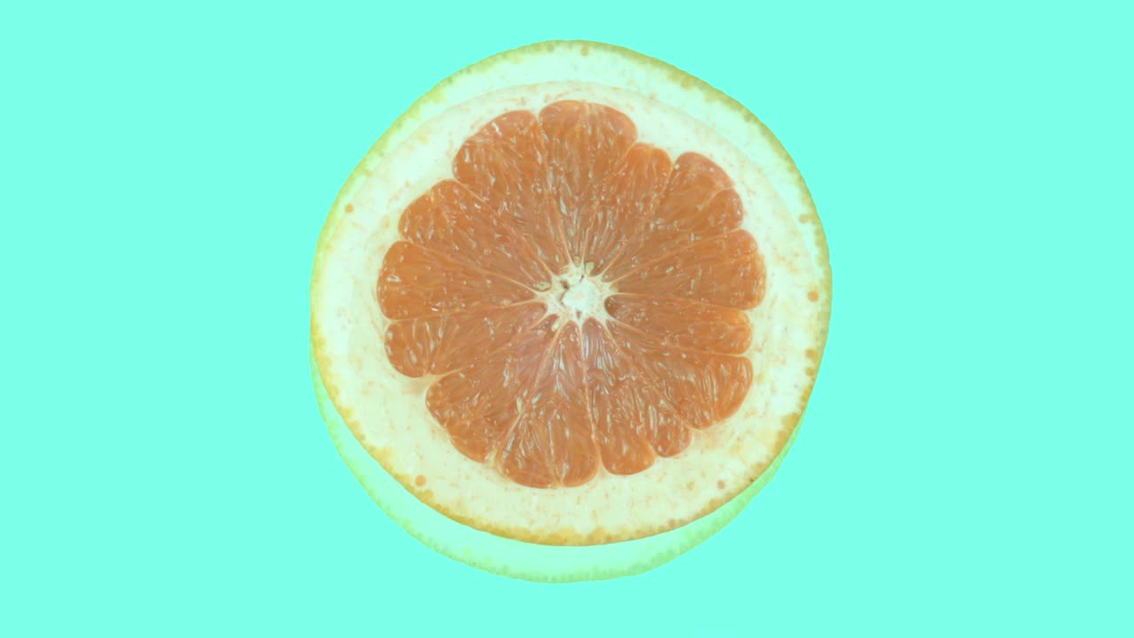las mitades de un pomelo y una naranja giran en diferentes direcciones contra un fondo de color cianuro. aislado.