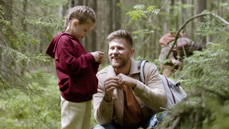 man and girl in the forest