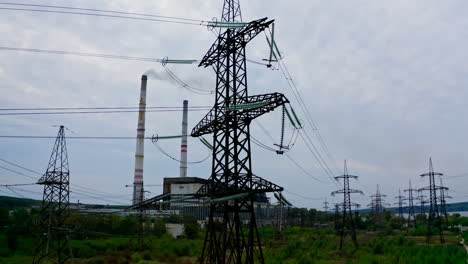 electricity pylons and high-voltage power lines on the green grass. power plant. electrical power grid. view from the top.