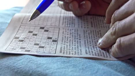 woman challenges her brain with a crossword puzzle