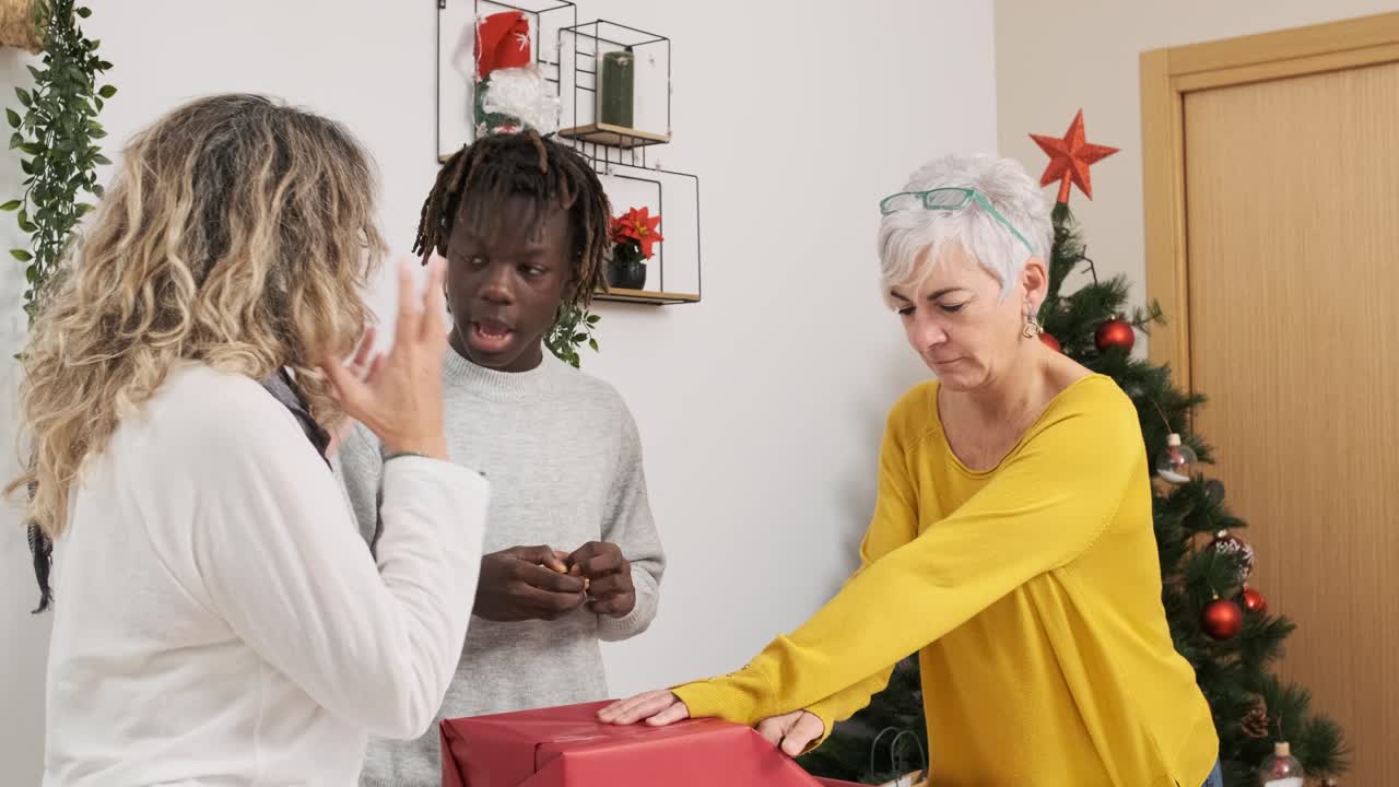 Family wrapping Christmas gifts together