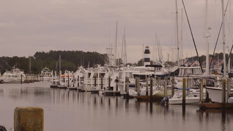 coastal marina with boats and lighthouse