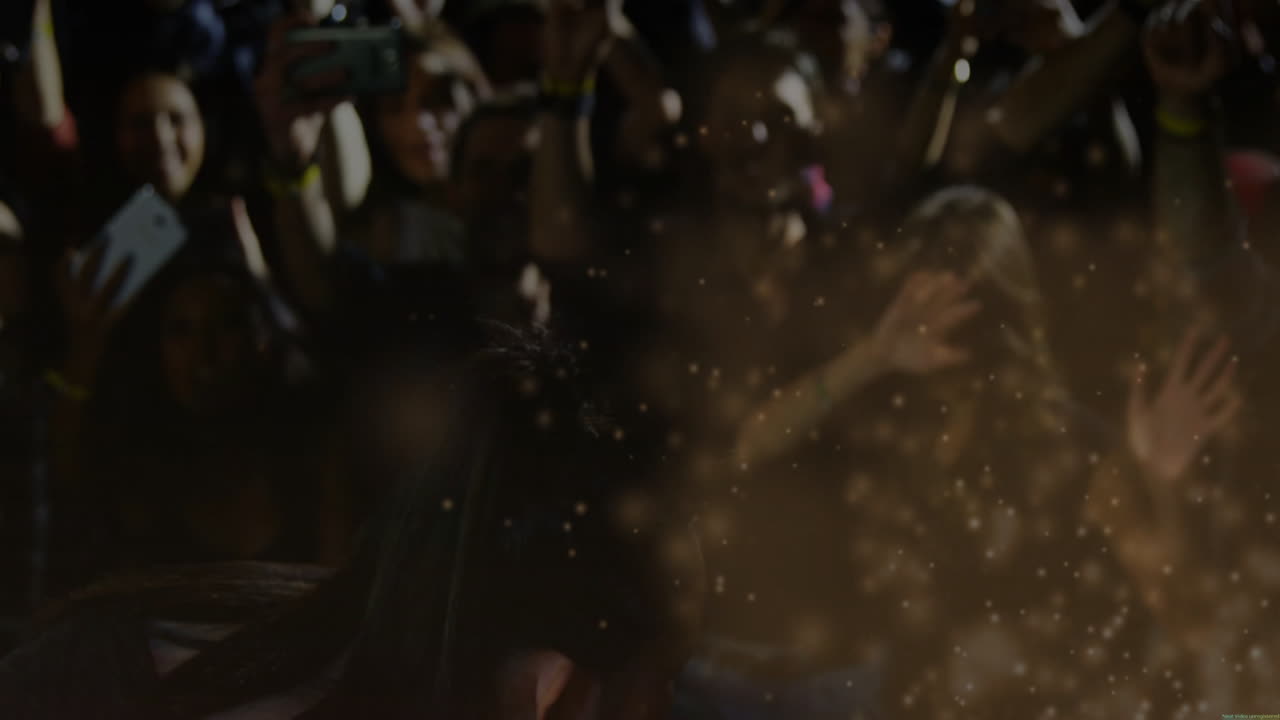 Female singer singing into microphone stage left, overlaying music spark icons onto audience phones