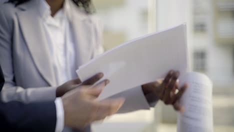 Cropped-shot-of-two-women-holding-documents