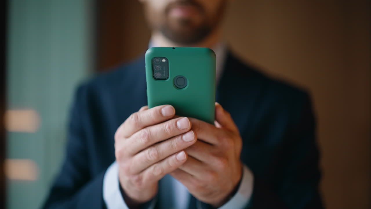 Executive hands holding mobile phone at company workspace closeup. Elegant man