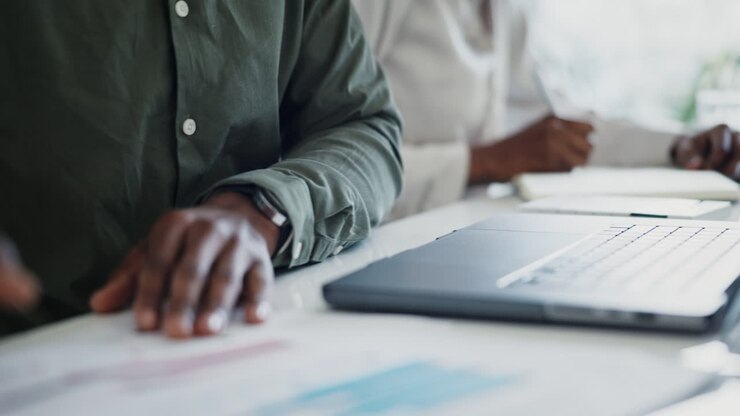Paperwork, laptop or hands of person doing data