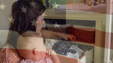 animación de la bandera de los estados unidos sobre feliz madre caucásica y bebé buscando ropa