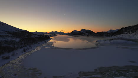 moody sunset high fly over frozen fjord during the polar night season - northern norway - scandinavia - jornfjorden