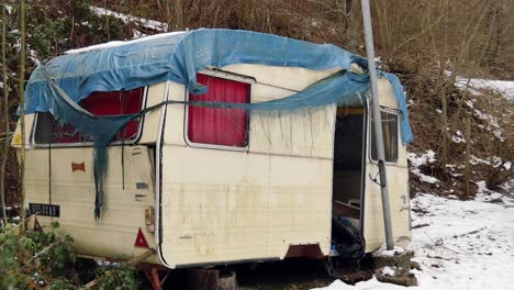 abandoned caravan in the forest pull away shot