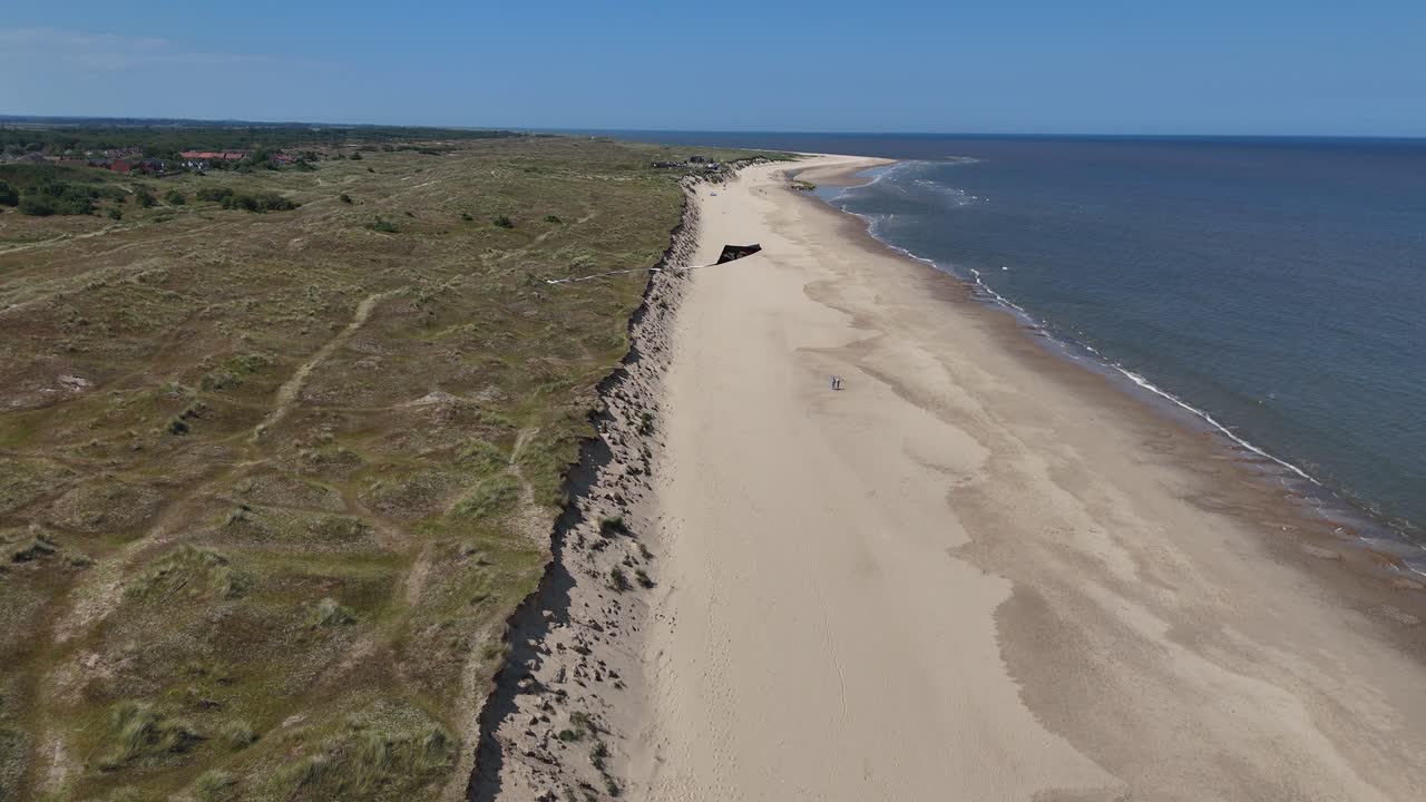 Drone,aerial Kite flying over North Norfolk UK beach blue sky background