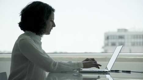 thoughtful businesswoman using laptop