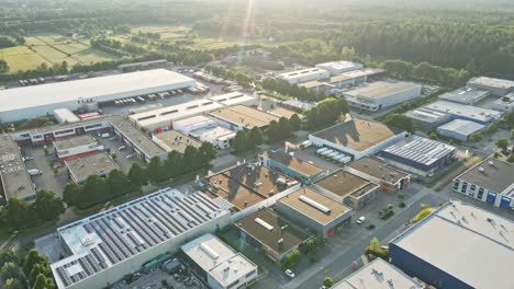 Aerial-of-stunning-industrial-terrain-with-buildings-filled-with-solar-panels-at-golden-hour