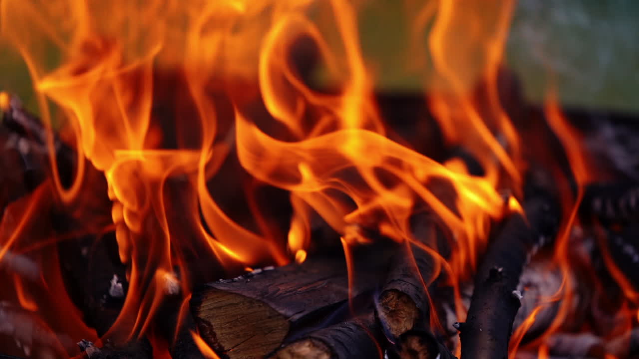 Detailed fire flame. Bright flame from wooden logs. Orange fire burning. Slow motion.