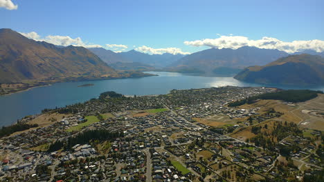 the historic, resort town on wanaka, new zealand on the shore of the glacial lake wanaka with an aerial view of the mountains