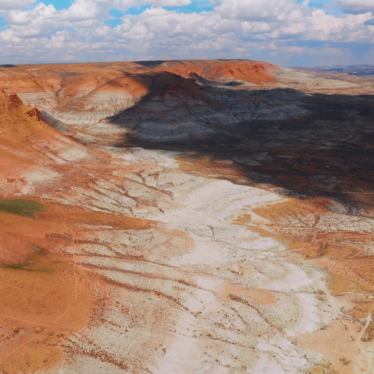 Cloudscape drooping shadow on the desert and mountains. Rocky landscape of Wyoming, United States from aerial view